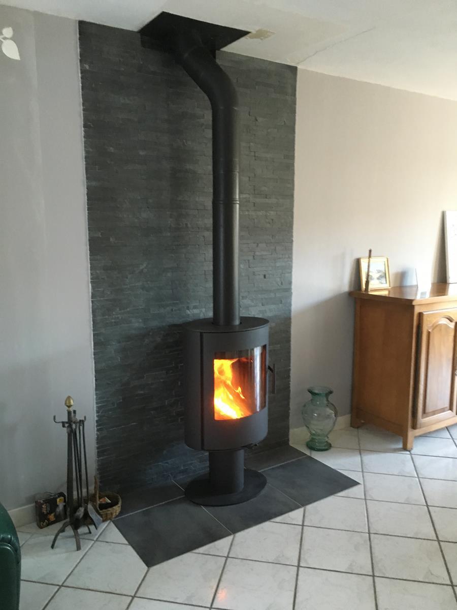 - Installation d'un poêle à bois ROMOTOP Evora T, finition acier, appareil tournant à 360°. L'intérieur du corps de chauffe est composé de fonte pour la sole foyère et de chamotte pour la chambre de combustion.